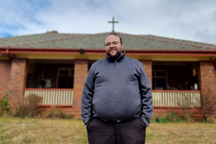 Man standing outside a convent.