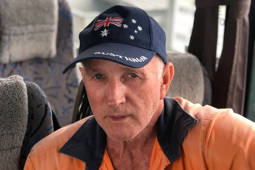 Jim Savage sits on a bus seat.
