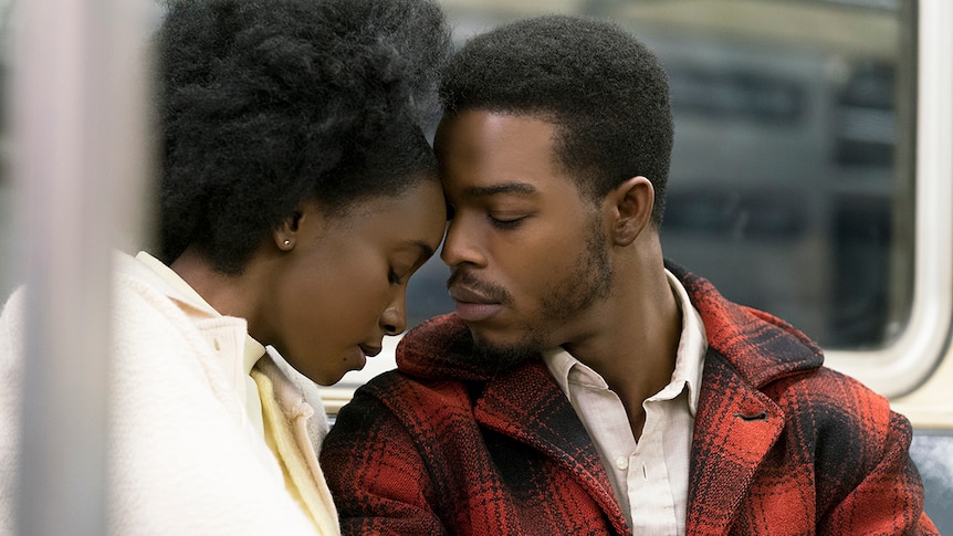 Colour still of KiKi Layne and Stephan James sitting with foreheads touching on subway in 2018 film If Beale Street Could Talk.