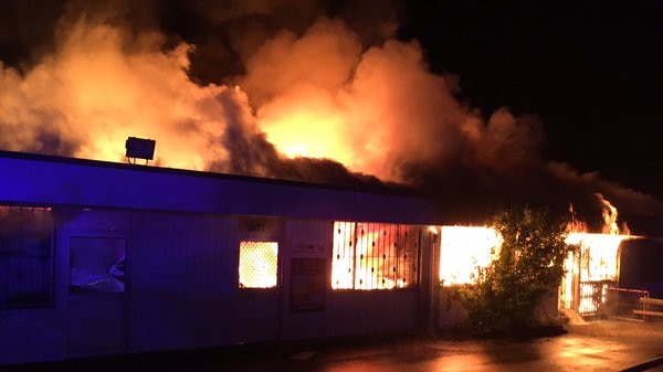 A toy warehouse at Bennetts Green in the NSW Lake Macquarie region engulfed by fire at night.