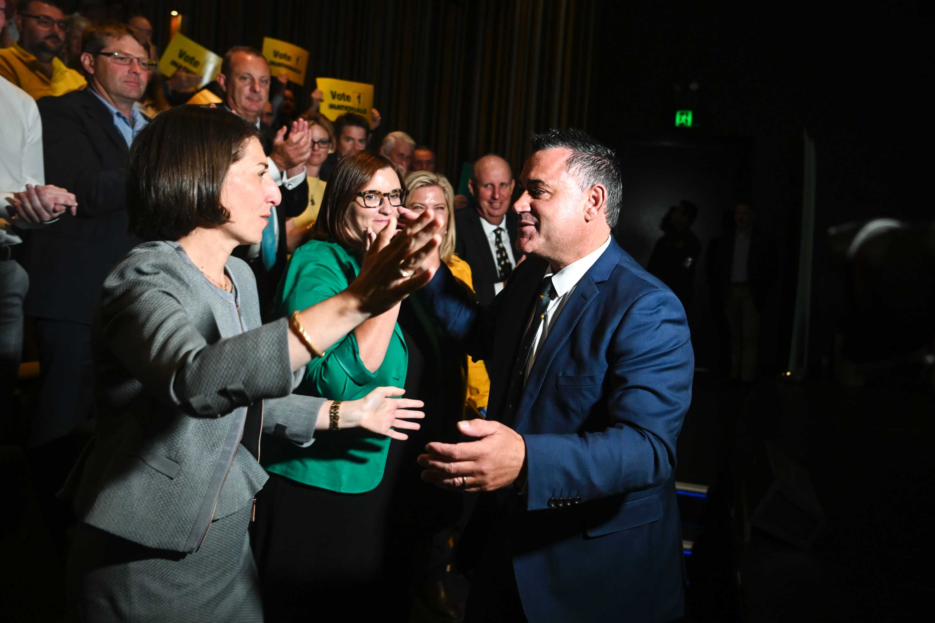 A woman and a man prepare to hug.