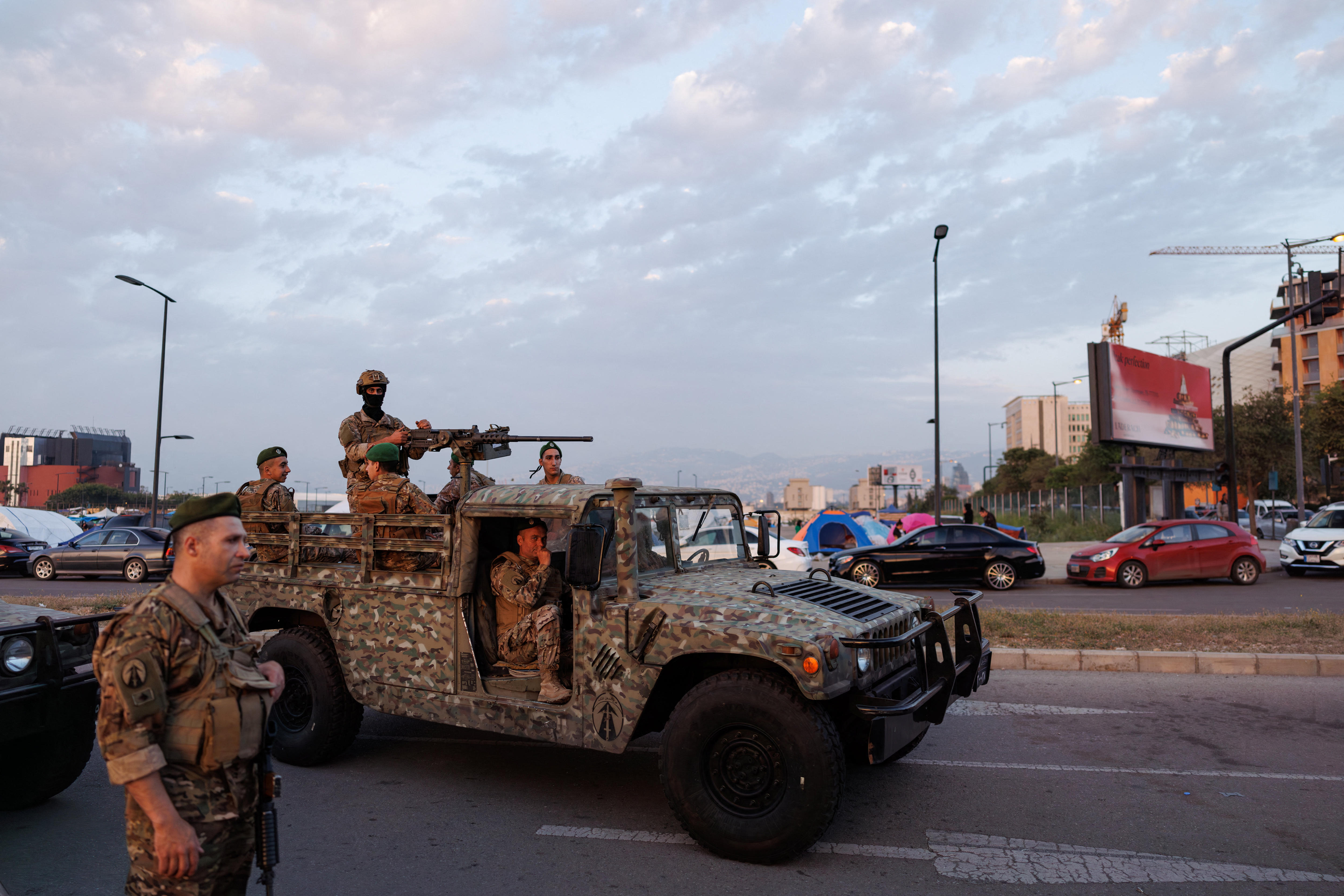 Men in military uniform in a military vehicle in the street