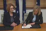 ACT Chief Minister Katy Gallagher and Prime Minister Julia Gillard sign an agreement on the NDIS.