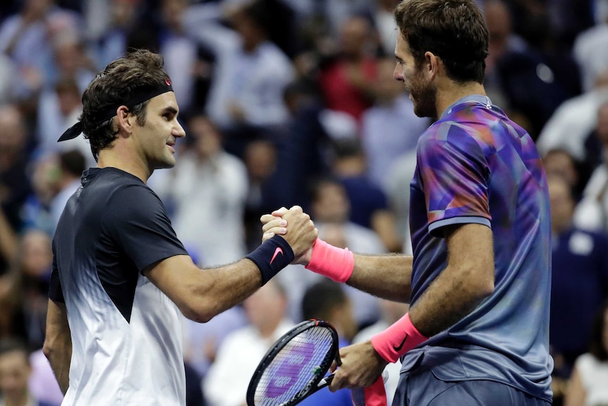 Roger Federer and Juan Martin del Potro shake hands at the net after their US Open quarter-final.