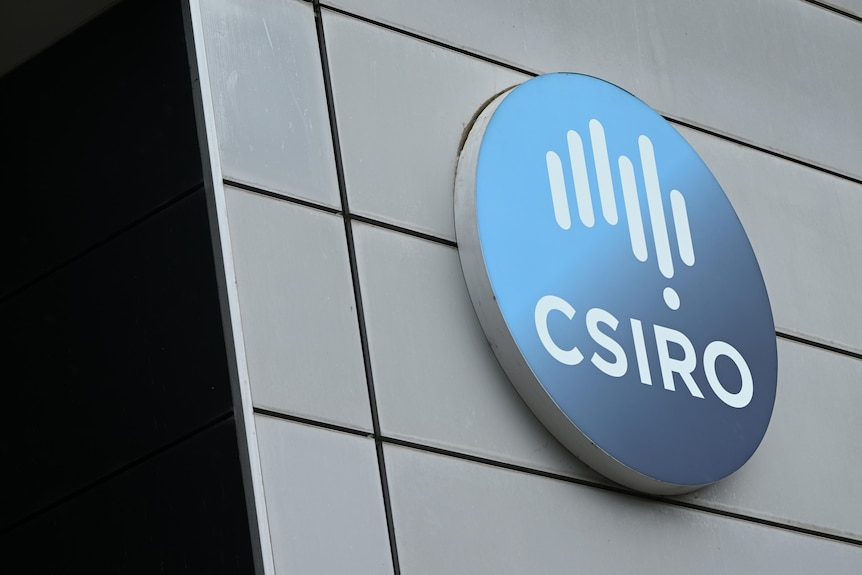 A large circular CSIRO logo on the side of a building.