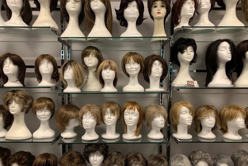 Wall of ladies' wigs.