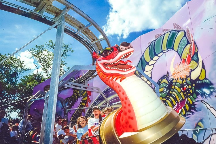 A dragon coaster carrying screaming adults and children