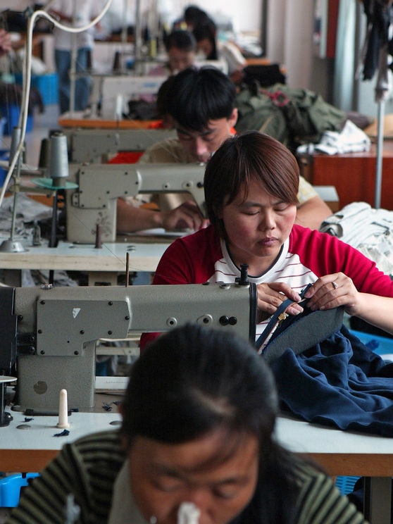 Chinese workers sChina's Government uses export subsidies to promote goods ranging from textiles to beer.ew clothes at a garments factory