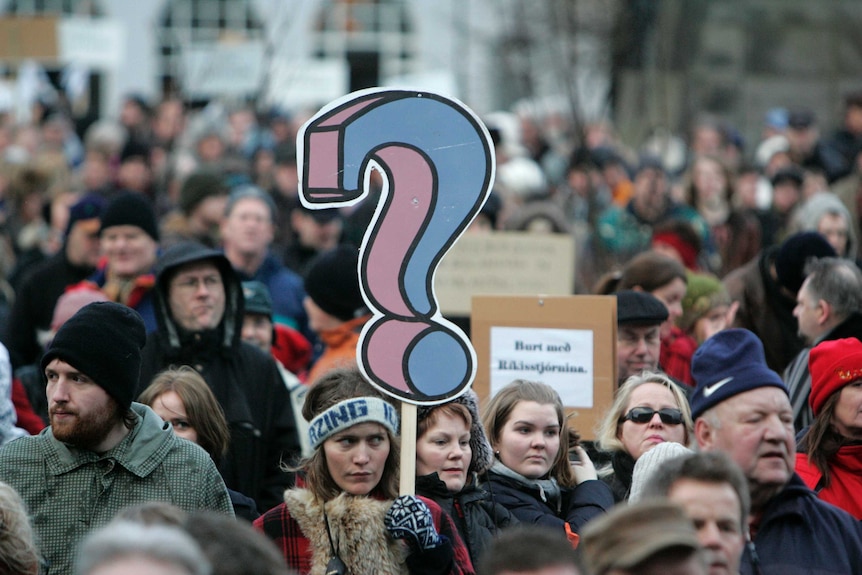 A woman protests near Iceland's Parliament