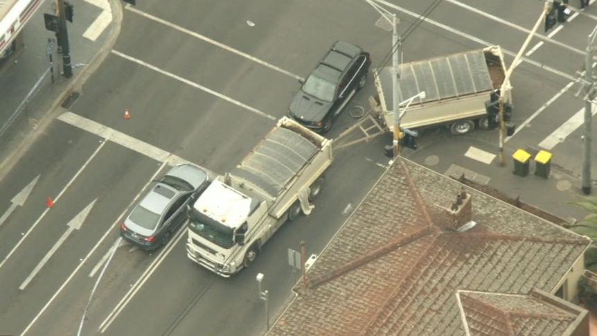 Aerial footage shows a truck which had been turning and a bicycle wheel on the road between its trays.