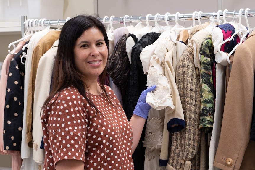 Queensland Museum's assistant curator of Queensland Stories Carmen Burton with Gay Welch fashion collection.