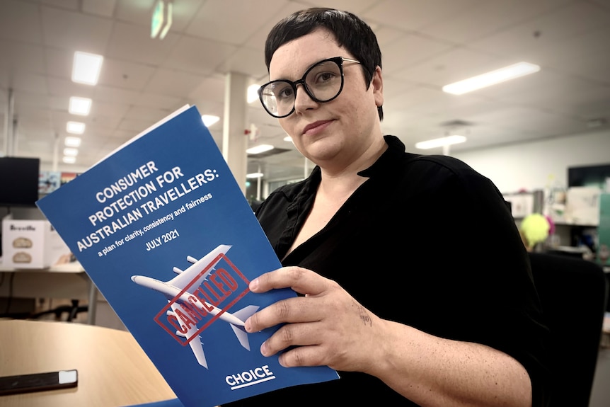 A woman hold a report in an office.