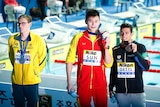 Sun Yang holding his medal while Mack Horton looks away