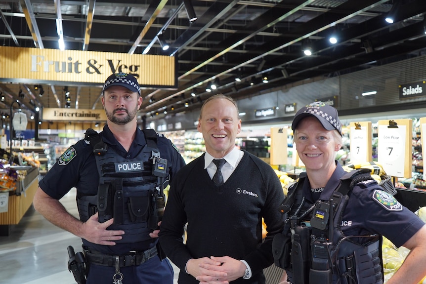 ohn Paul Drake standing in his store with local police called to help fight theft in his Adelaide stores.
