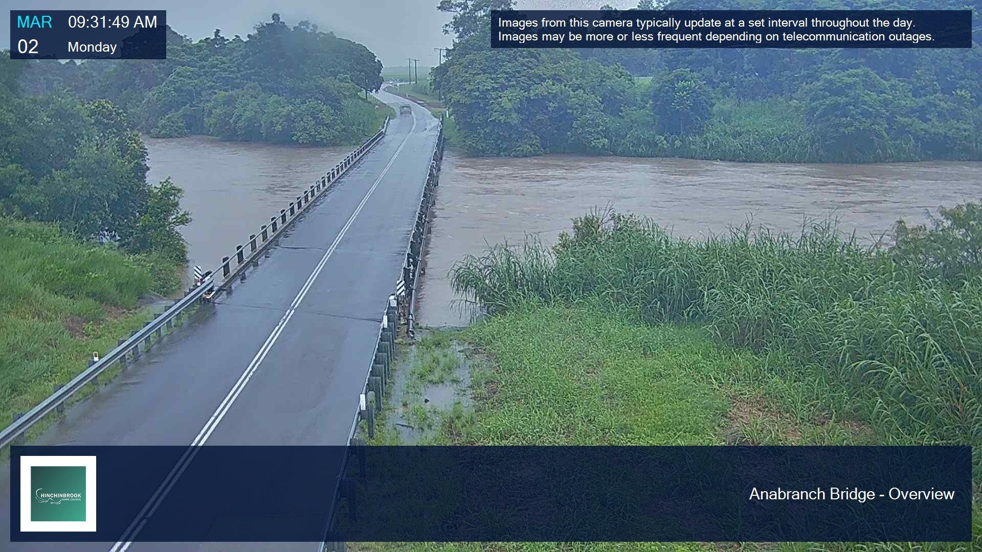bridge over swollen river where water is almost overing road.