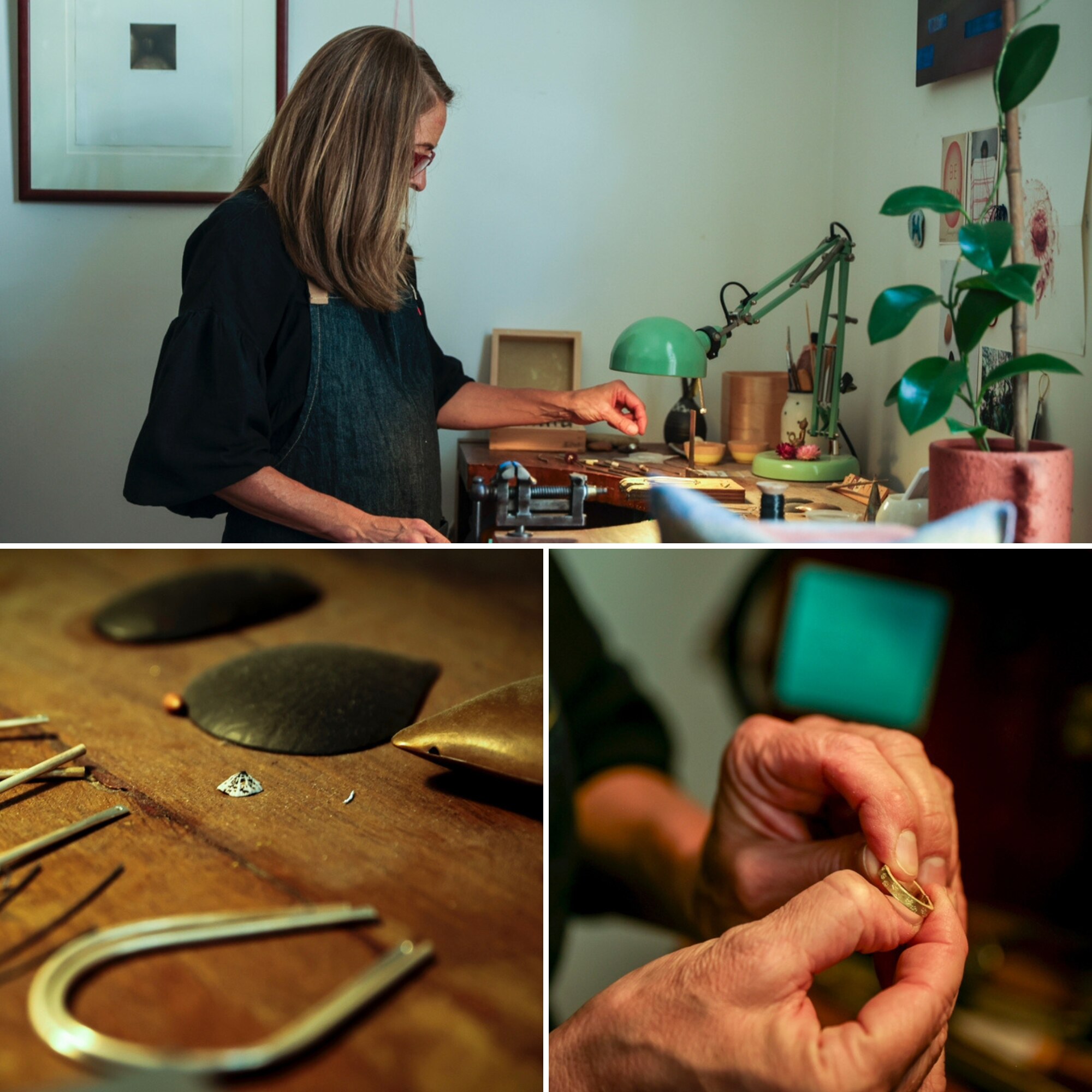 A woman with long brown hair works on jewellery under a lamp at a desk