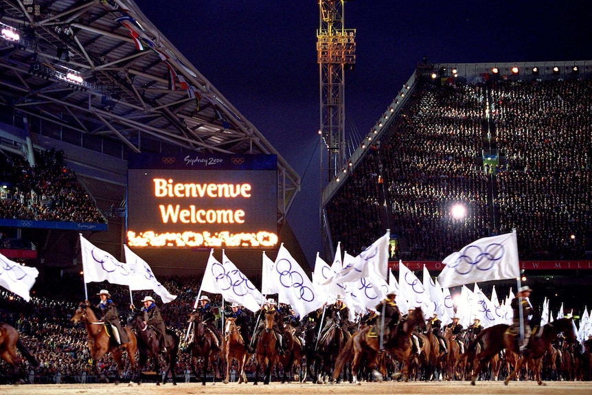 Horseriders carry Olympic flags at the Opening Ceremony of the Sydney Olympics in September 2000.