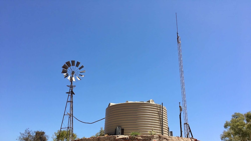 A windmill, tank and signal tower on a remote property in WA