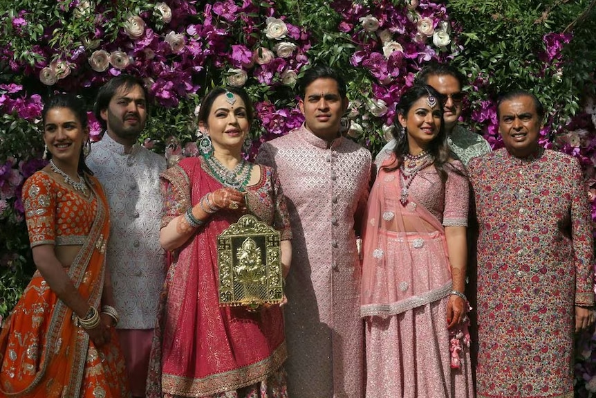 A family dressed in bright coloured traditional Indian clothing