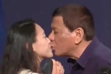 Philippines President Rodrigo Duterte kisses a woman.