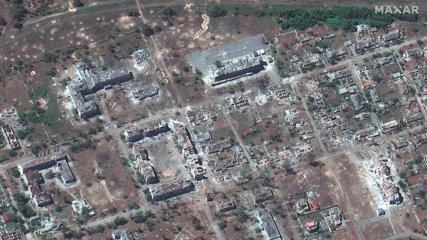 Satellite image of destroyed buildings in a town. 