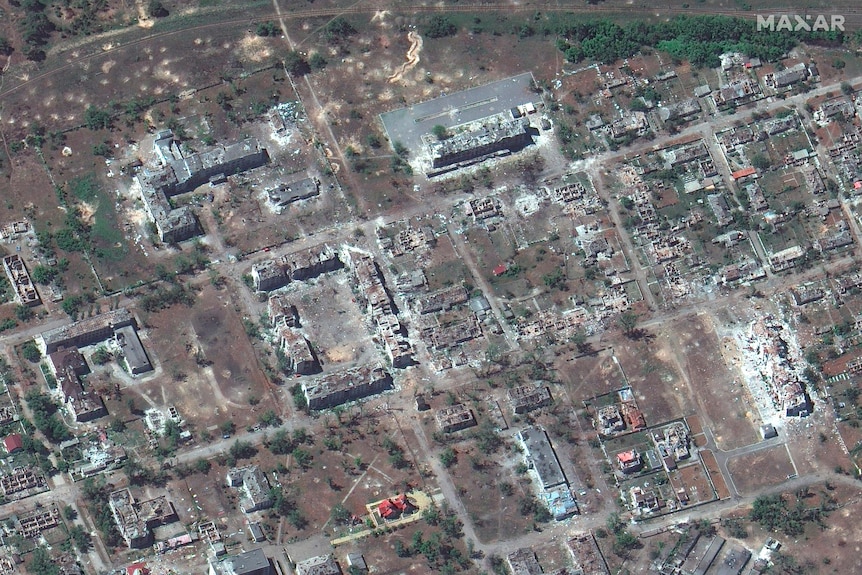 Satellite image of destroyed buildings in a town. 