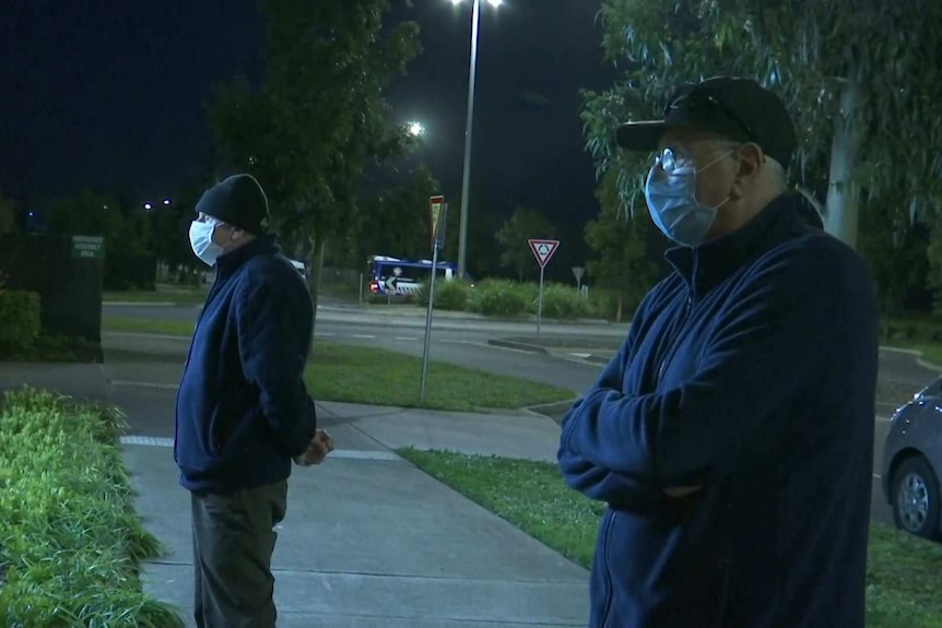 Jim and Peter Staffieri waiting in the dark outside Epping Gardens Aged Care home.