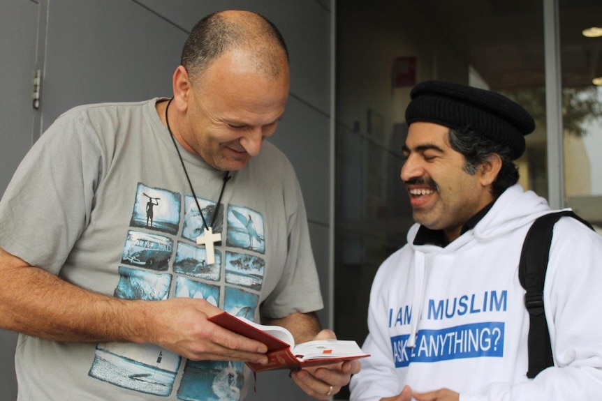 A man chats to one of the I Am A Muslim Ask Me Anything team on the street.