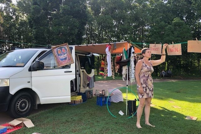 A woman outside her van with all her possessions