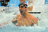 One to go: Michael Phelps celebrates his narrow win in the 100m butterfly final.