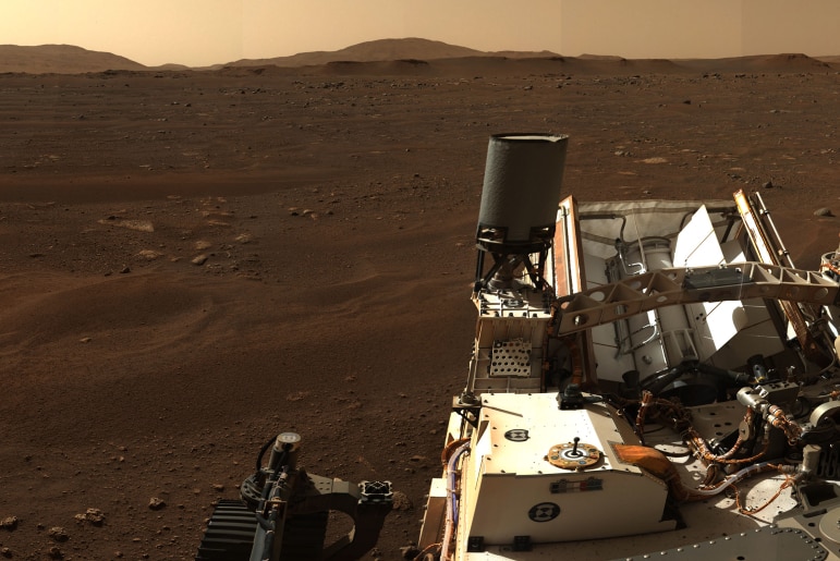 A mountain is seen in the distance on Mars