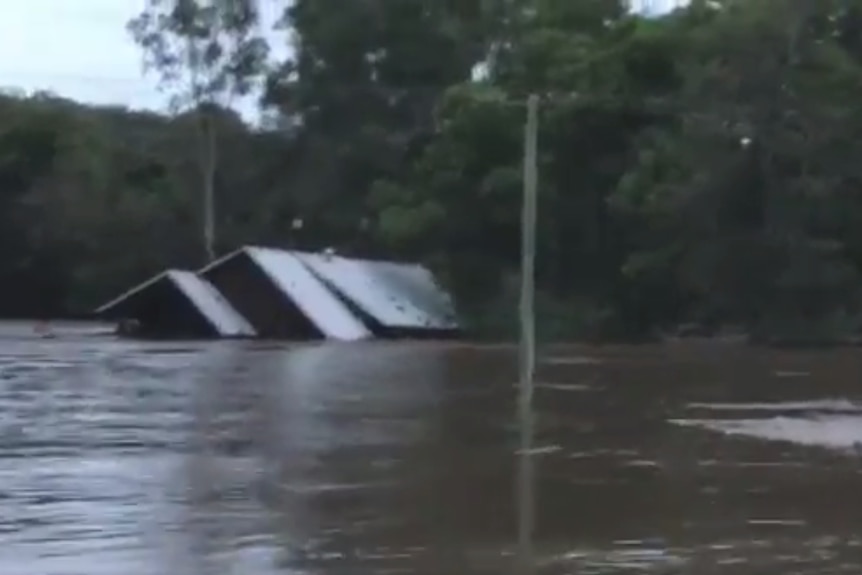 A house is swept away in floodwaters in Luscombe on April 1 2017.