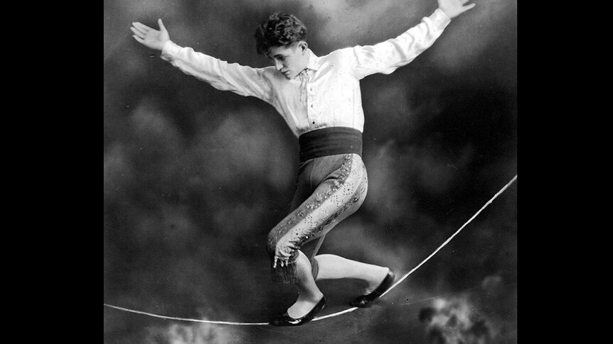 Black and white photograph from the 1920s of Con Colleano walking on a slack wire, in a circus act.