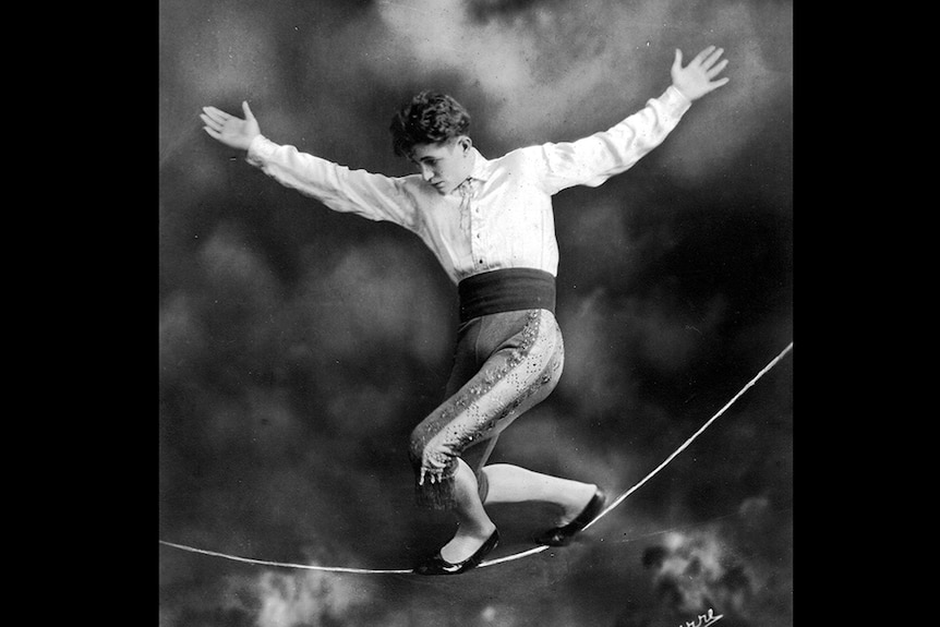 Black and white photograph from the 1920s of Con Colleano walking on a slack wire, in a circus act.