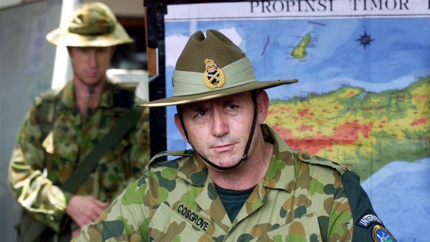 Peter Cosgrove fronts a press conference in military uniform.