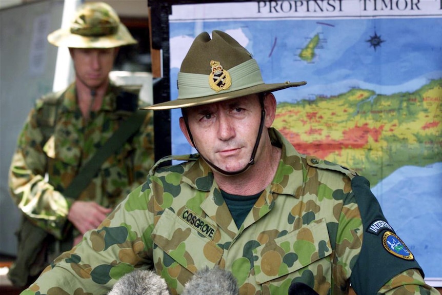 Peter Cosgrove fronts a press conference in military uniform.