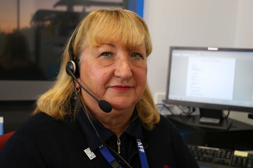 Mental health nurse Glynis Thorp has her headset on for talking to patients over the phone