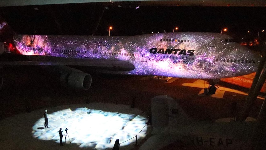 A light display illuminates an old 747 at the Qantas Founders Museum in Longreach.