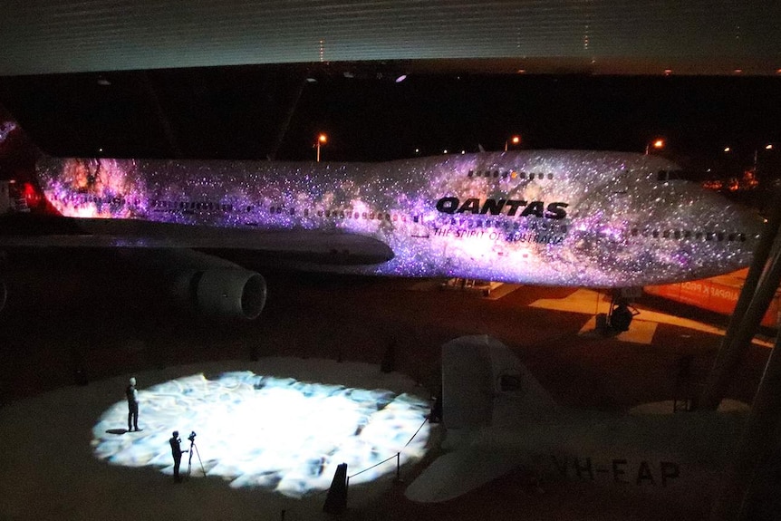 A light display illuminates an old 747 at the Qantas Founders Museum in Longreach