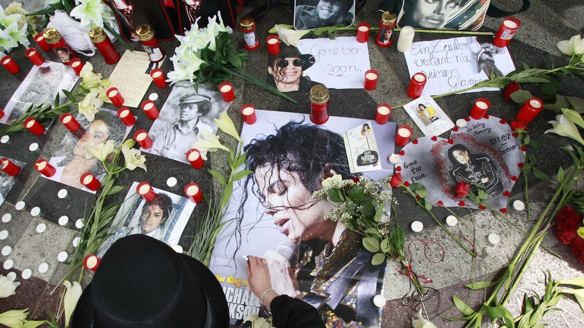 A Michael Jackson fan in Berlin lights candles to commemorate the King of Pop's death.