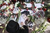 A Michael Jackson fan in Berlin lights candles to commemorate the King of Pop's death.