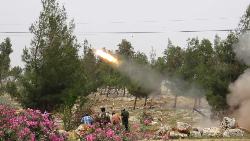 Free Syrian Army fighters fire a rocket in clashes with government forces.