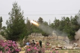 Free Syrian Army fighters fire a rocket in clashes with government forces.