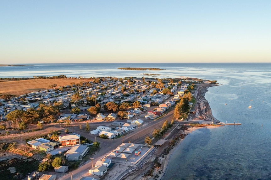 An aerial view of the township overlooking the  bay at sunset.