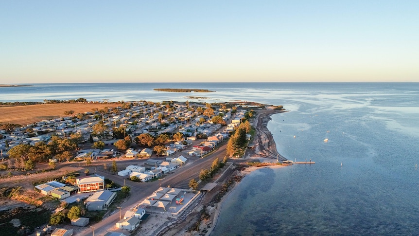An aerial view of the township overlooking the  bay at sunset.