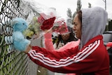 Student places flowers following Marysville school shooting
