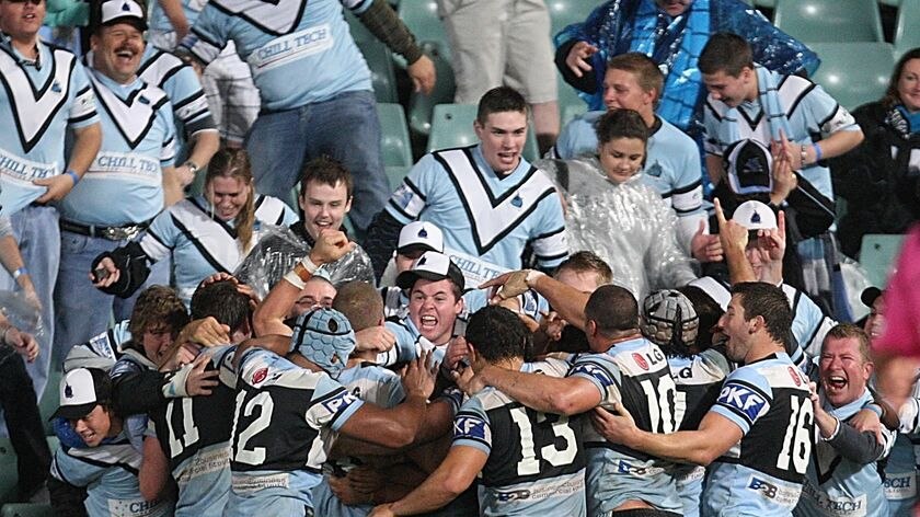Sweet relief... Sharks players erupted jubilantly in joint celebration with the travelling fans.