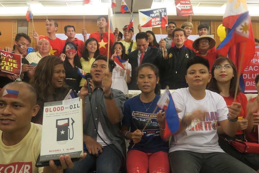 People wave the Philippines' flag and cheer.