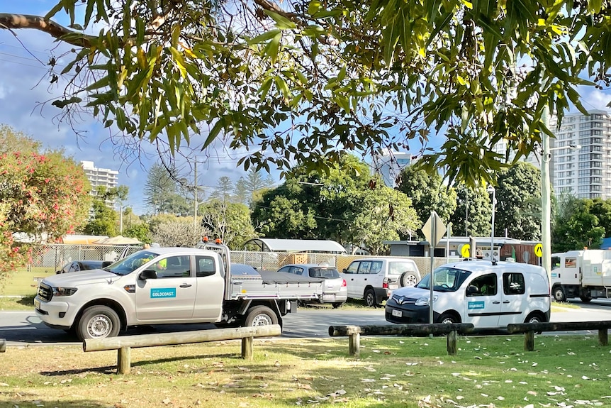 Two Gold Coast Council vehicles parked beside a park.