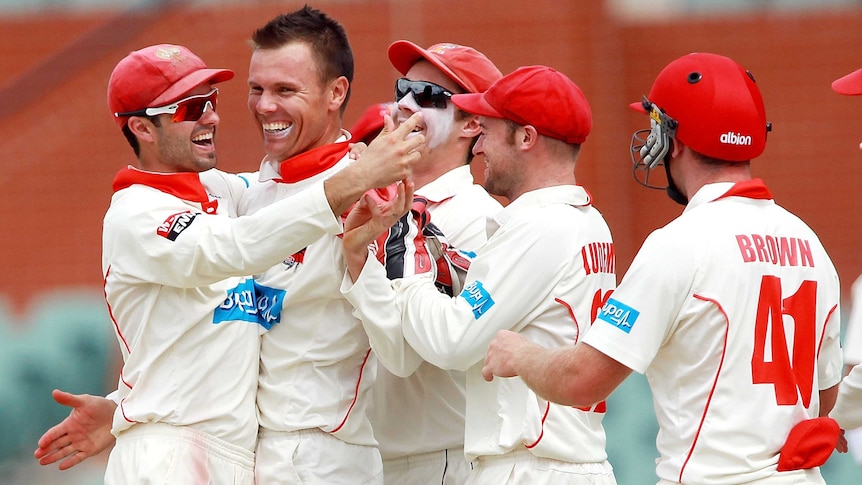The Redbacks congratulate captain Johan Botha in the Shield game against the Warriors in Adelaide.